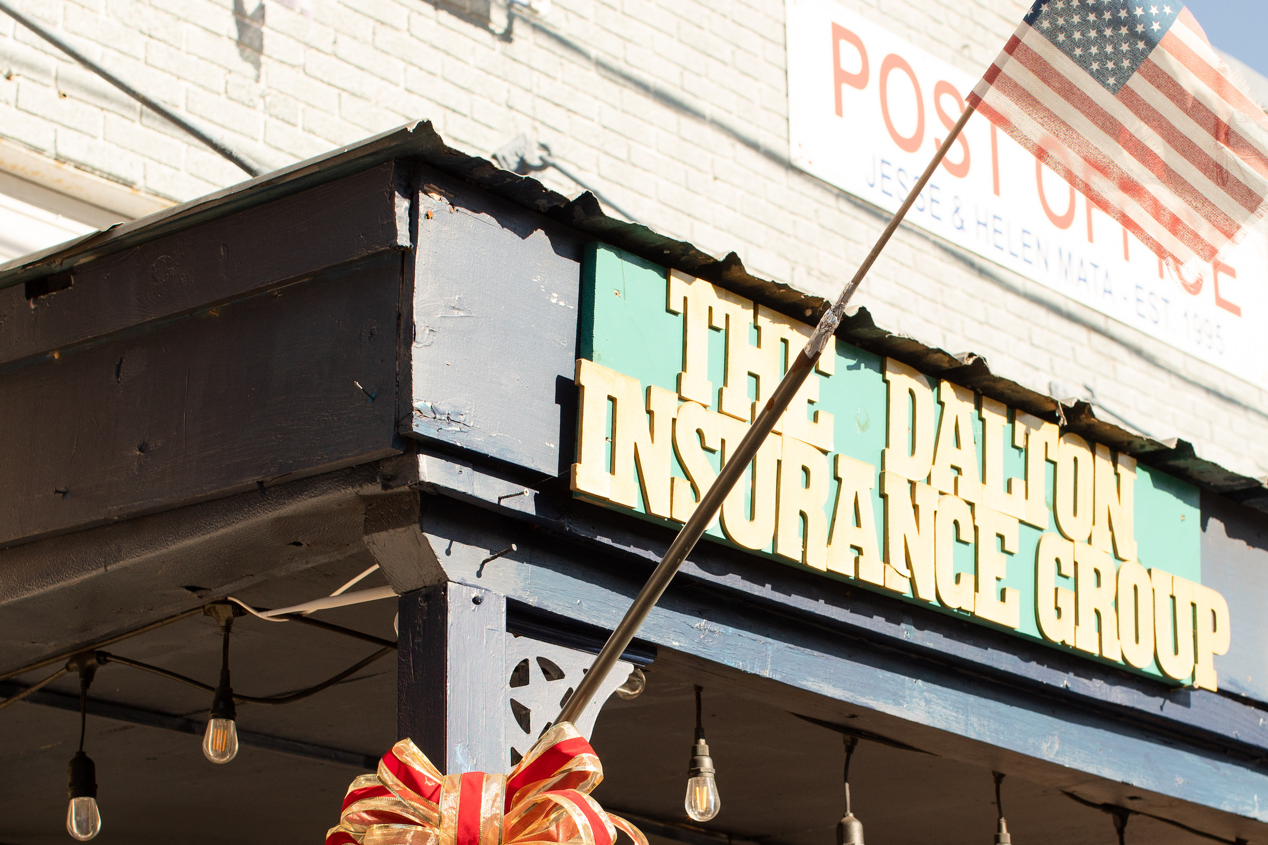 The Dalton Insurance Group Sign with american flag and christmas wreath