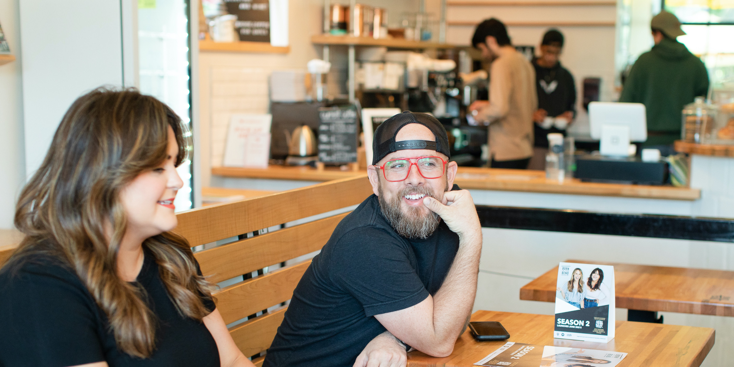 Coworkers reviewing documents in a coffee shop.