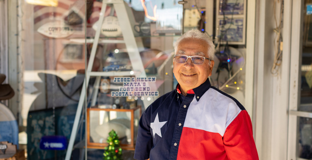 local business owner outside shop wearing a texas flag button down shirt