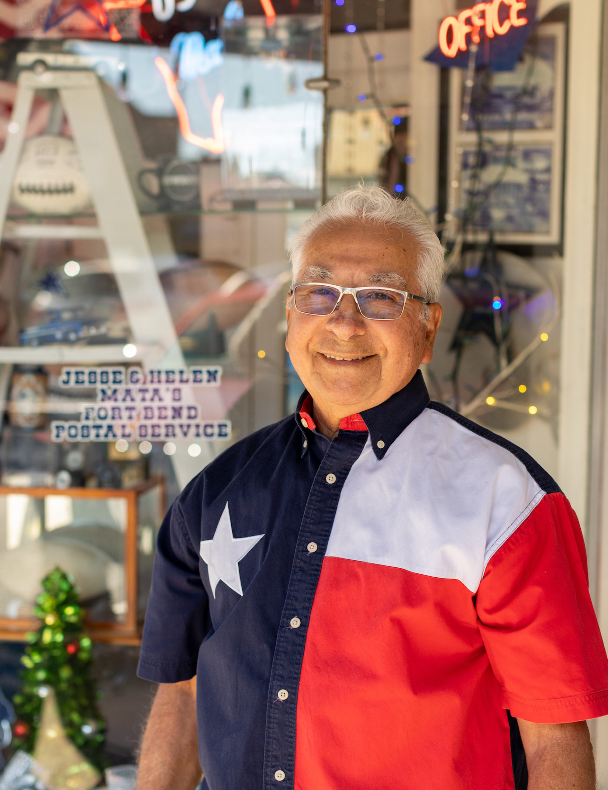 local business owner outside shop wearing a texas flag button down shirt